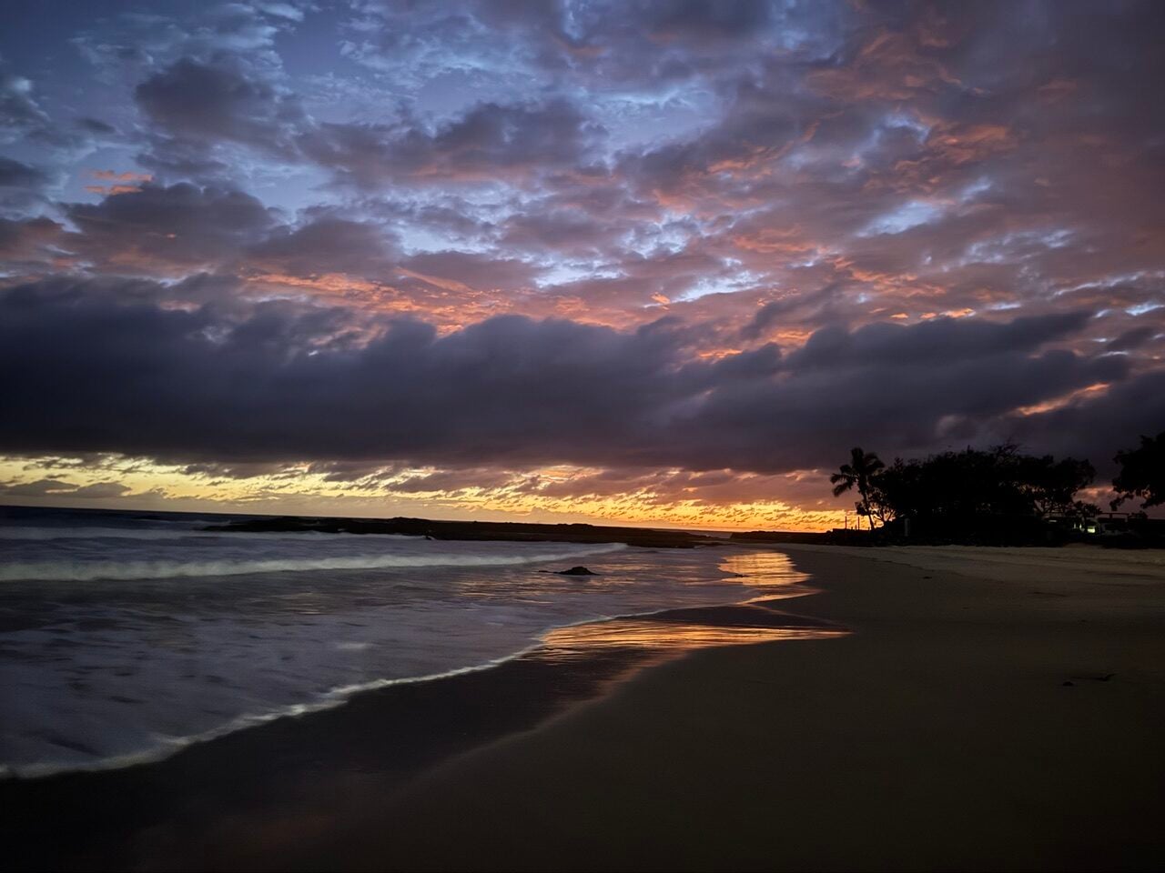 blues, pinks and gold skies over an ocean shore dawn