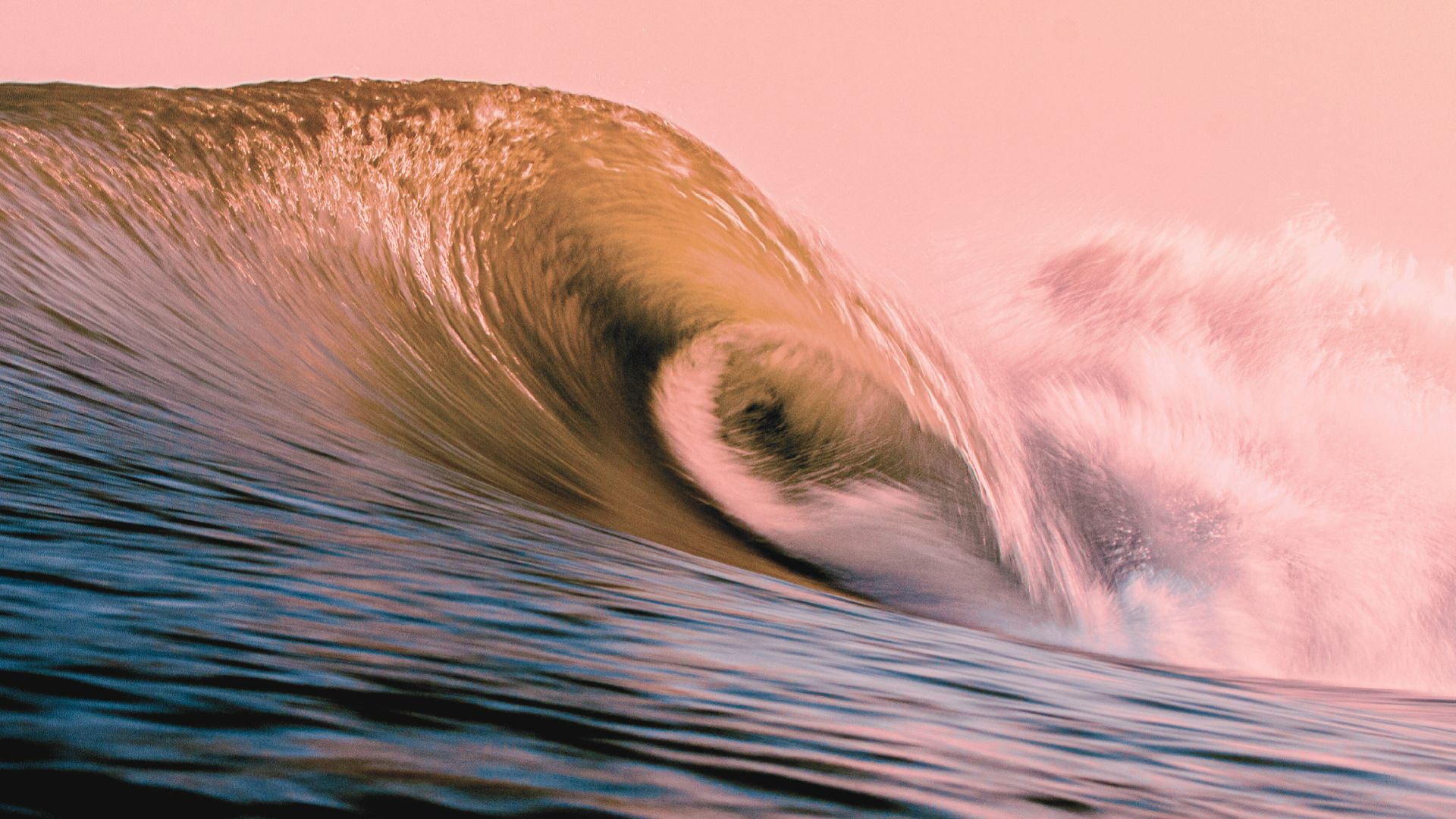 Large curling ocean wave forming a hollow barrel at sunset." (avoid stray quote)