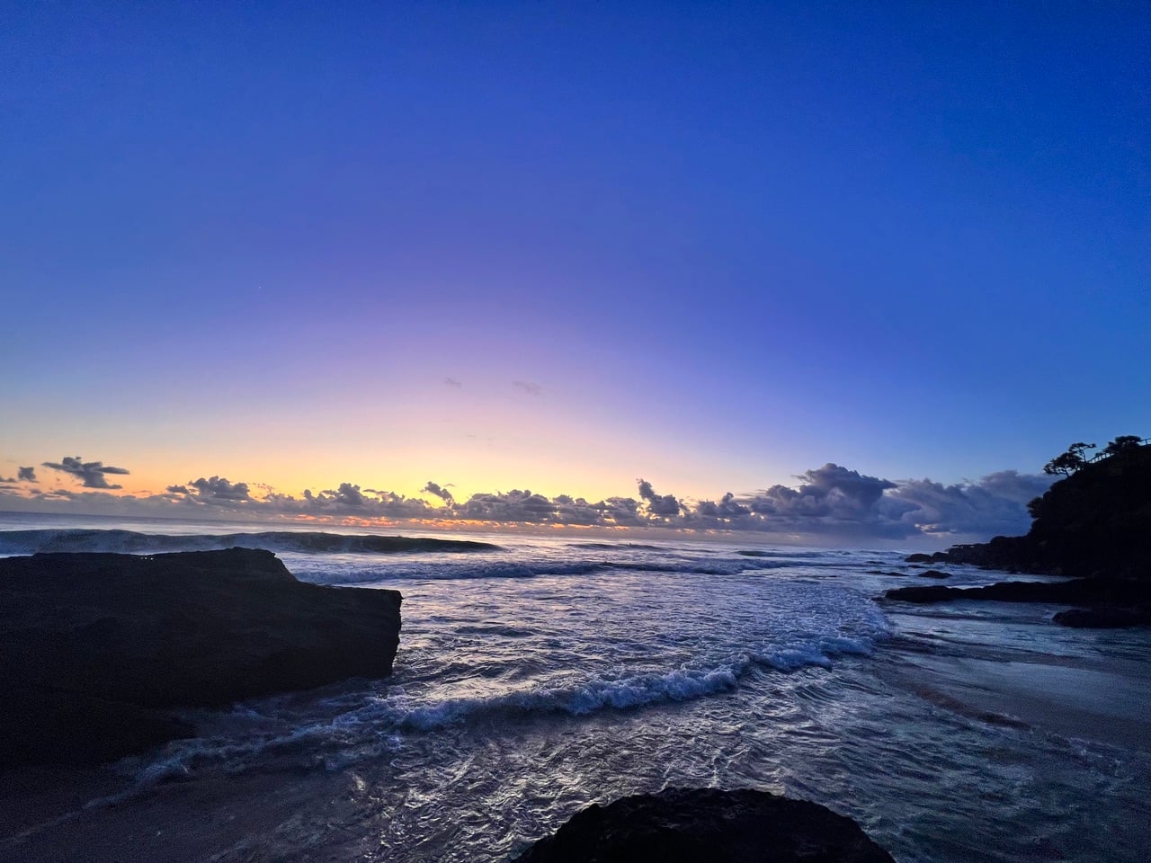 bright blue sky, sunrise over ocean.