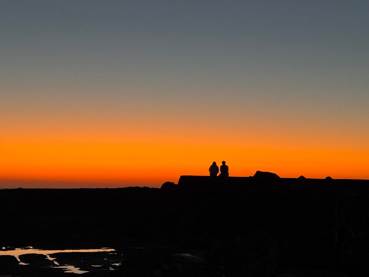 golden sunrise with silouette of two people