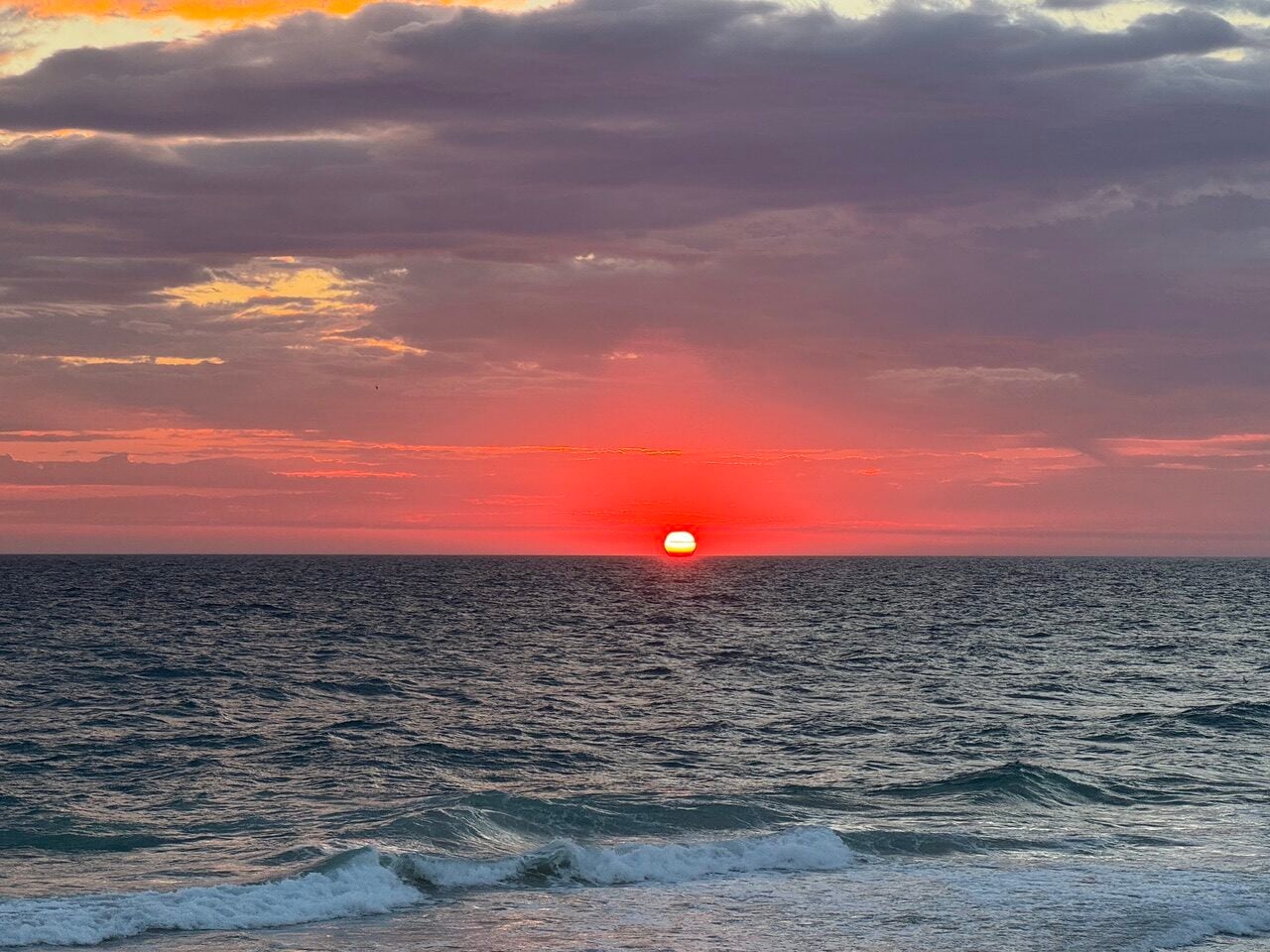 red orange sunrise over ocean